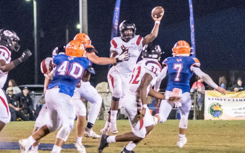 Fort White quarterback Tyler Jefferson throws a pass to Kamarion Griffin during Friday’s Region 3-1A quarterfinal against Branford. (CHRISTINA FEAGIN/Special to the Reporter)