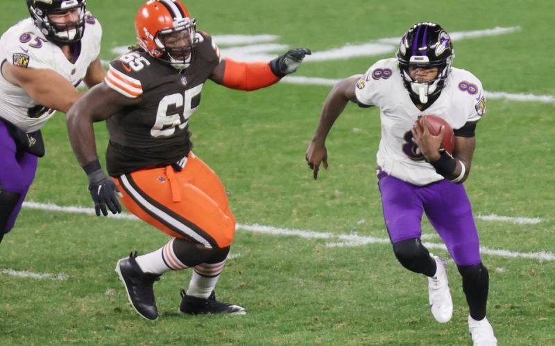 Baltimore quarterback Lamar Jackson scrambles away from pressure Monday night against Cleveland. (JOHN KUNTZ/cleveland.com/TNS)