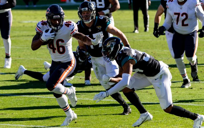 Chicago Bears running back Artavis Pierce (46) stiff arms Jacksonville Jaguars cornerback Greg Mabin (34) in the fourth quarter at TIAA Bank Field on Sunday in Jacksonville. (MATT PENDLETON/TNS)