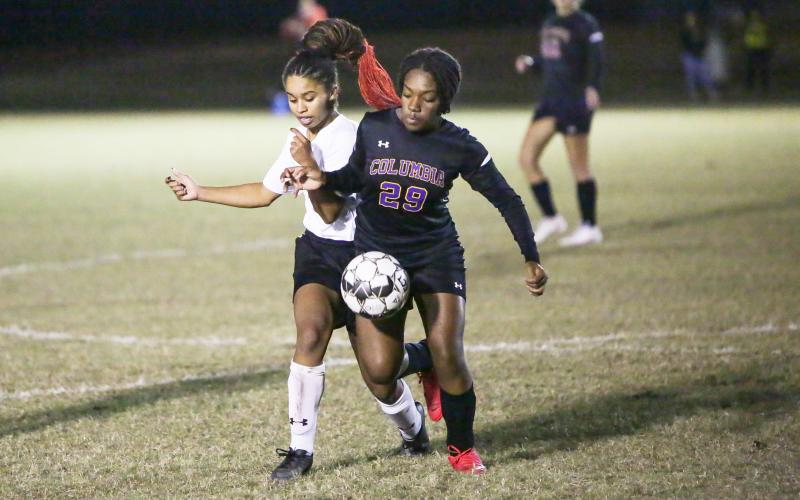 Columbia’s Olivia Kelly fights for possession of the ball with Fort White’s Alyssa Hopkins during Wednesday night’s match. (BRENT KUYKENDALL/Lake City Reporter)