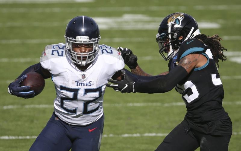 Tennessee Titans running back Derrick Henry (22) gains yardage as he tries to get around Jacksonville Jaguars cornerback Sidney Jones on Sunday in Jacksonville. (STEPHEN B. MORTON/Associated Press)