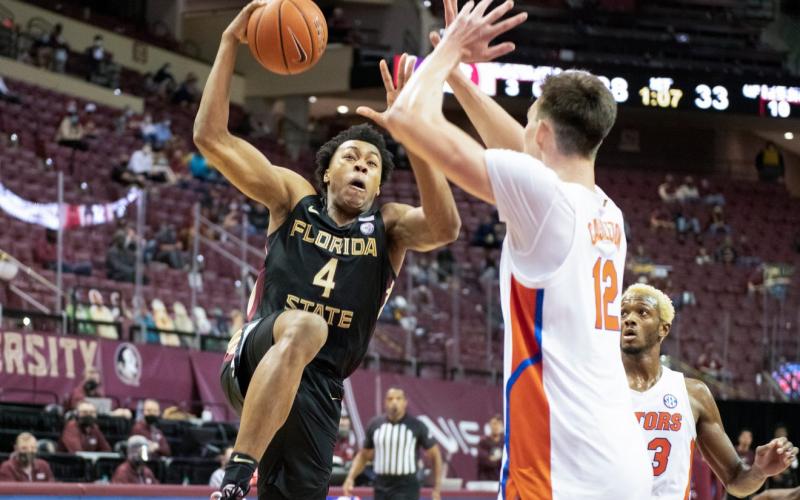 Florida State's Scottie Barnes drives on Florida's Colin Castleton during Saturday's game in Tallahassee. (MIGUEL OLIVELLA/Courtesy of ACC)