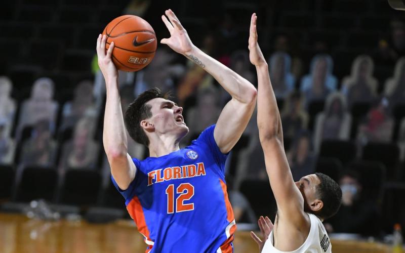 Florida forward Colin Castleton (12) shoots as Vanderbilt forward Dylan Disu defends on Wednesday in Nashville, Tenn. Florida won 91-72. (JOHN AMIS/Associated Press)