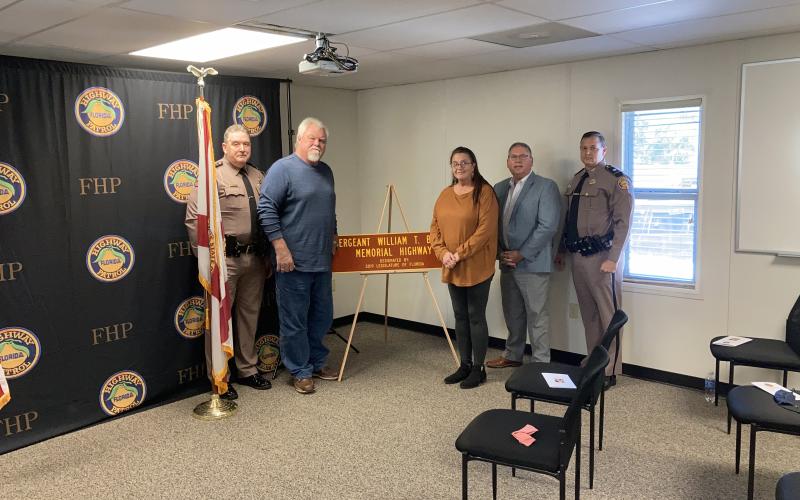 A stretch of Interstate 75 was designated the Sergeant William T. Bishop Memorial Highway on Tuesday. Present for the dedication for the late Florida Highway Patrol trooper were Colonel Gene Spaulding, FHP director (from left); Charles Barnes, Bishop’s brother-in-law; Vanessa Barnes, Bishop’s sister; Chuck Brannan, District 10 state representative; and FHP Lt. Colonel Troy Thompson. (COURTESY)
