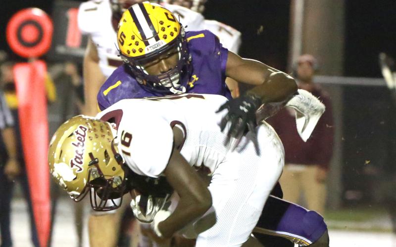 Columbia’s Shyheim Brown tackles St. Augustine running back Ty Baxter during Friday’s Region 1-6A final. (JEN CHASTEEN/Special to the Reporter)