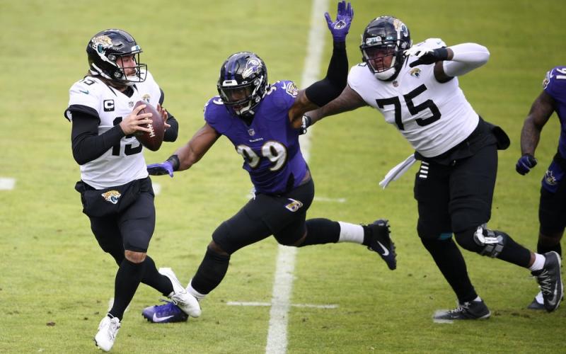 Baltimore Ravens linebacker Matthew Judon (99) gets by Jacksonville Jaguars offensive tackle Jawaan Taylor (75) as quarterback Gardner Minshew II (15) looks to throw a pass on Sunday in Baltimore. (NICK WASS/Associated Press)