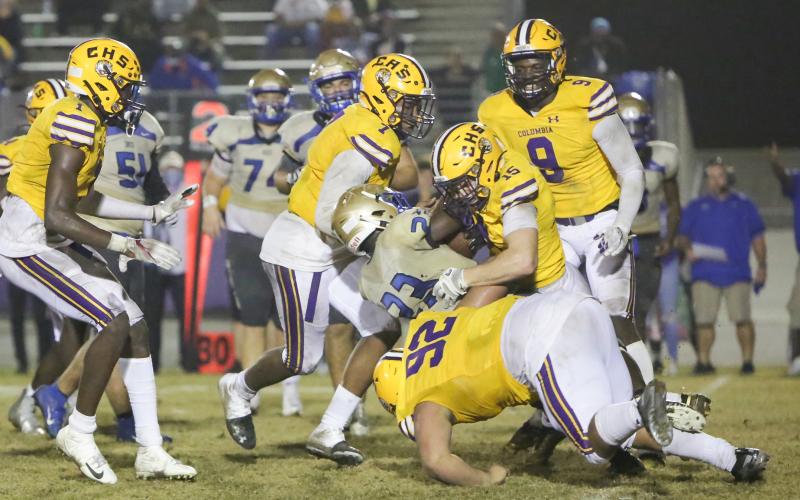 Columbia linebacker Jaden Dunn (15), defensive end A’Deon Farmer (7) and defensive lineman Nate Walmsley (92) tackle Daytona Beach Mainland running back Gregory Mango during last Friday’s Region 1-6A semifinal. (BRENT KUYKENDALL/Lake City Reporter)