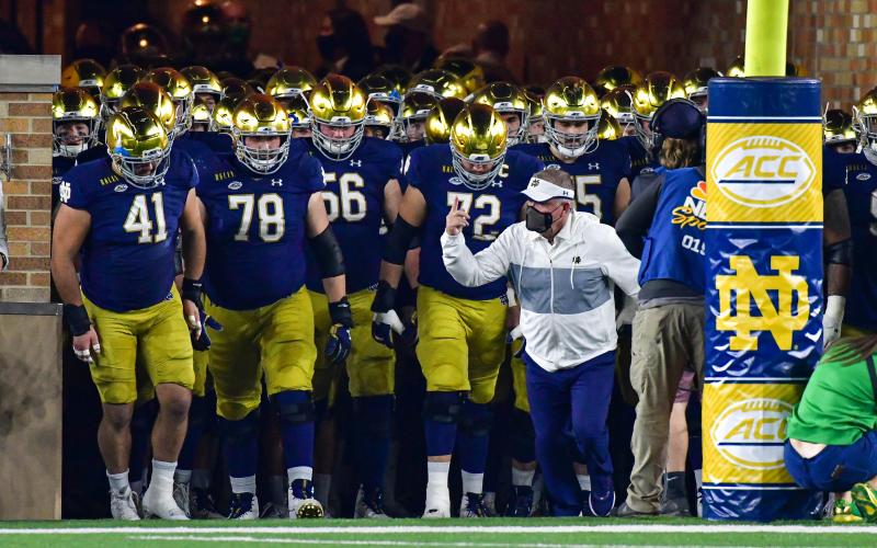 Notre Dame head coach Brian Kelly, leading the Fighting Irish out of the tunnel before a game against Clemson at Notre Dame Stadium on Nov. 7, 2020, in South Bend, Indiana, was named the Atlantic Coast Conference Coach of the Year. (MATT CASHORE/Pool/Getty Images/TNS)