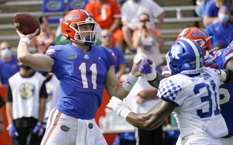 Florida quarterback Kyle Trask (11) throws a pass as Kentucky linebacker Jamar Watson (31) rushes on Saturday in Gainesville. (JOHN RAOUX/Associated Press)
