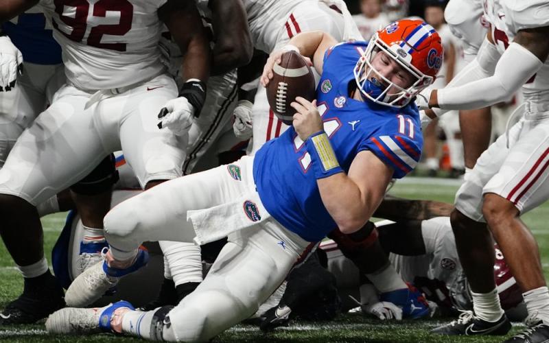 Florida quarterback Kyle Trask (11) leaps into the end zone for a touchdown against Alabama during the first half of the Southeastern Conference championship on Saturday in Atlanta. (BRYNN ANDERSON/Associated Press)
