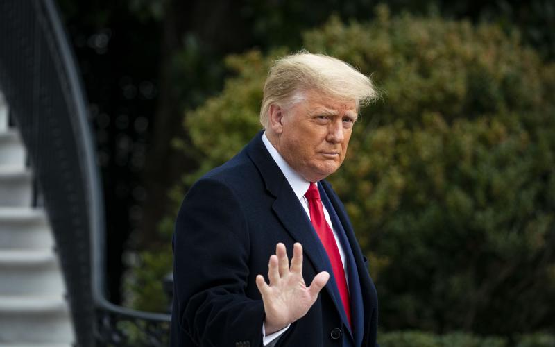 President Donald Trump waves as he departs on the South Lawn of the White House on Dec. 12 in Washington, D.C. (AL DRAGO/Getty Images/TNS)