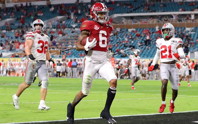 Alabama Crimson Tide receiver DeVonta Smith rushes for a 42-yard touchdown against the Ohio State Buckeyes during the College Football Playoff National Championship game on Monday in Miami Gardens. (KEVIN C. COX/Getty Images/TNS)