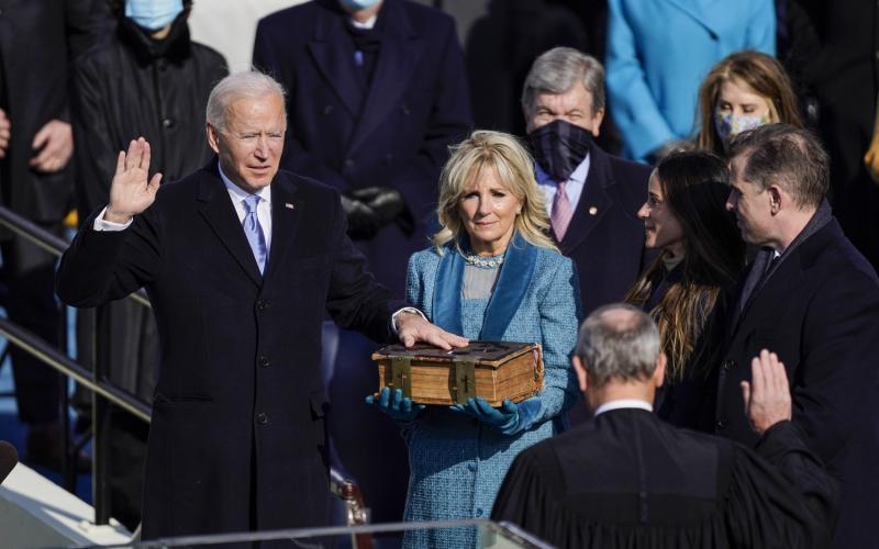 U.S. President-elect Joe Biden takes the oath of office from Supreme Court Chief Justice John Roberts as his wife U.S. First Lady-elect Jill Biden stands next to him during the 59th presidential inauguration on Wednesday in Washington, D.C. (KENT NISHIMURA/Los Angeles Times/TNS)