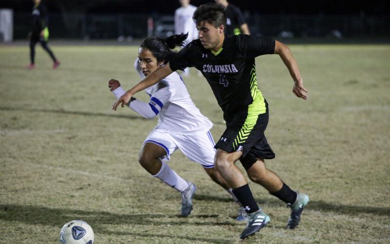 Columbia’s Marcos Medina-Rodriguez chases down possession of the ball against Keystone Heights on Monday night. (BRENT KUYKENDALL/Lake City Reporter)
