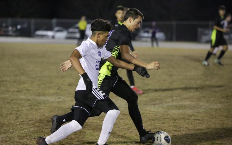 Gainesville’s Elesio Perez chases after possession from Columbia’s Bryant Rigdon on Tuesday night. (BRENT KUYKENDALL/Lake City Reporter)