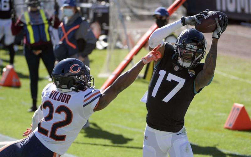 Jacksonville Jaguars wide receiver DJ Chark Jr. (17) catches a pass for a touchdown in front of Chicago Bears cornerback Kindle Vildor (22) on  Dec. 27, 2020, in Jacksonville. (PHELAN M. EBENHACK)