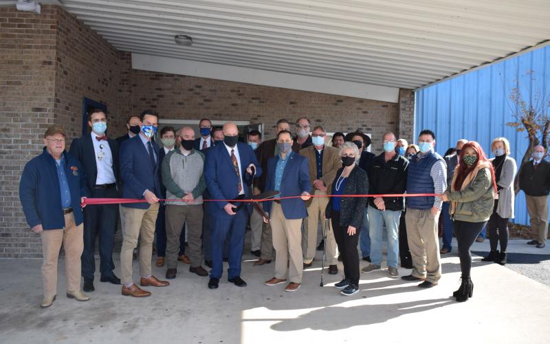 Lawrence Barrett, Florida Gateway College president, prepares to cut the ribbon Thursday afternoon at the grand opening of the college’s new multipurpose building in the former Boys Club of Columbia County facility. Joining Barrett were FGC officials, Florida Chancellor of Career Technical Programs Henry Mack and local dignitaries and residents. (COURTESY FLORIDA GATEWAY COLLEGE)