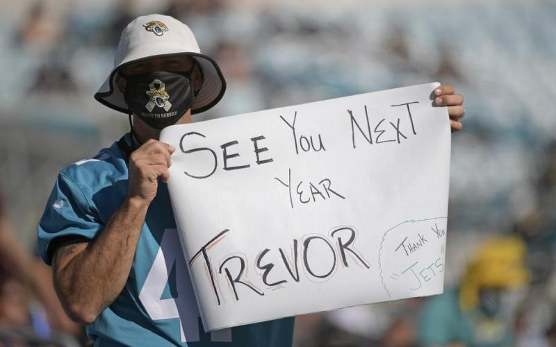 A Jacksonville Jaguars fan hold up a sign hoping that Clemson quarterback Trevor Lawerence will be the first pick for the Jacksonville Jaguars during a game against the Chicago Bears on Dec. 27, 2020, in Jacksonville. (PHELAN M. EBENHACK/Associated Press)