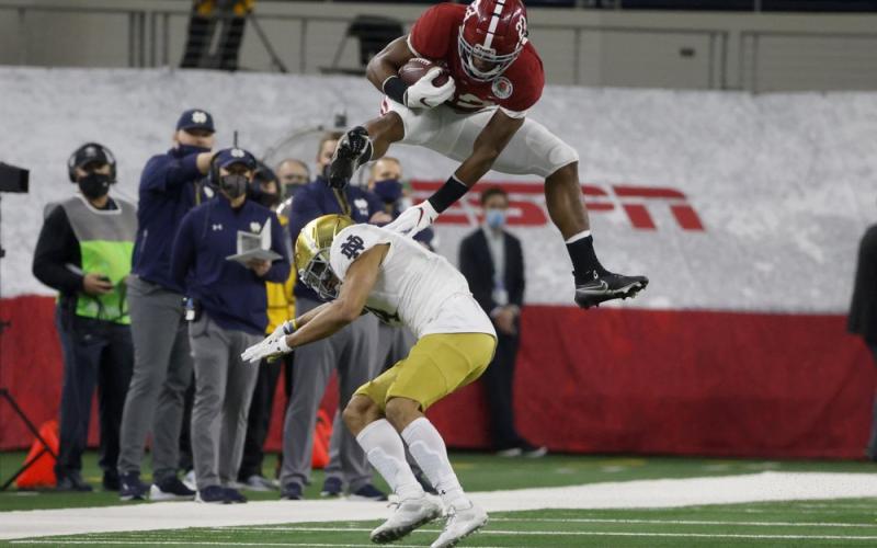 Alabama running back Najee Harris (22) fights off a tackle attempt by Notre Dame linebacker Marist Liufau (35) in the first half of the Rose Bowl on Jan. 1 in Arlington, Texas. (MICHAEL AINSWORTH/Associated Press)