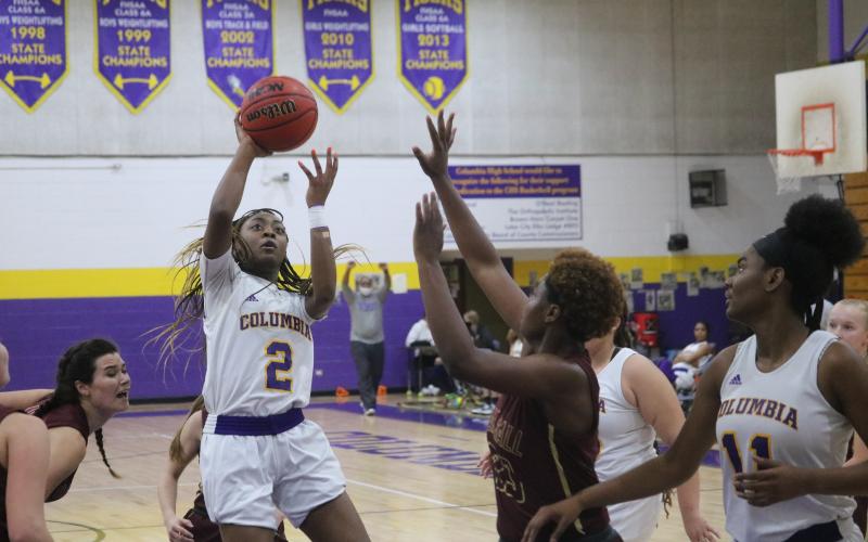 Columbia guard Na’Haviya Paxton puts up a shot over Oak Hall guard Tyla Young during Friday night’s game. Paxton had a triple-double with 20 points, 10 rebounds and 10 assists. (JORDAN KROEGER/Lake City Reporter)