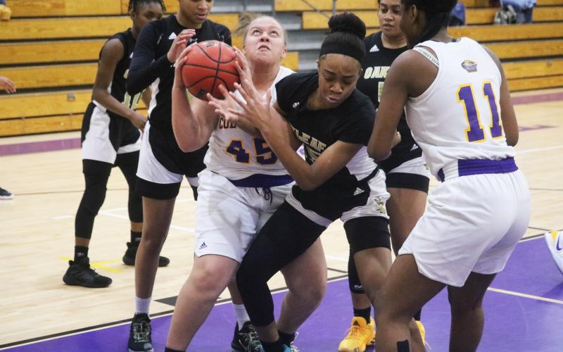 Columbia forward Amaiya Callum and Oakleaf forward Fantasia James fight for the ball during Friday’s game. (JORDAN KROEGER/Lake City Reporter)