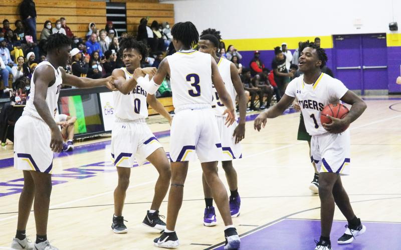 Columbia teammates help Dante Brown (0) off of the floor and celebrate after Brown made a layup while getting fouled by Suwannee on Friday night. (JORDAN KROEGER/Lake City Reporter)