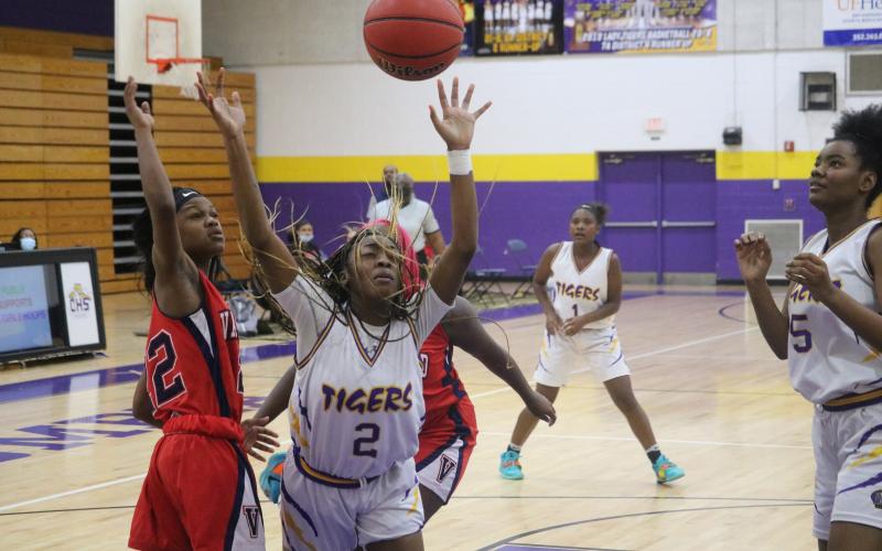 Columbia guard Na’Haviya Paxton is fouled by Vanguard’s Jadah Kingcade as she drives to the basket on Tuesday night. (JORDAN KROEGER/Lake City Reporter)