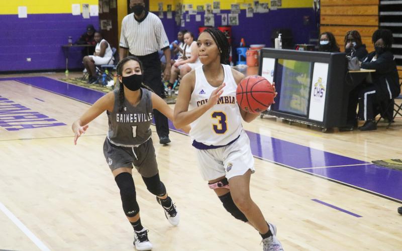 Columbia guard Camille Perry drives past Gainesville guard Layla Canales on Wednesday night. (JORDAN KROEGER/Lake City Reporter)