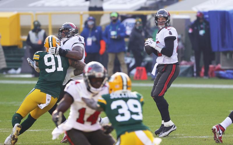 Tampa Bay Buccaneers quarterback Tom Brady looks to pass in the first quarter against the Green Bay Packers during the NFC Championship game on Sunday at Lambeau Field in Green Bay, Wisconsin. (STACY REVERE/Getty Images/TNS)
