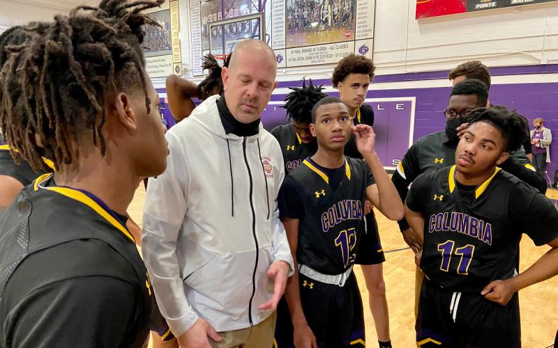 Columbia coach Steve Faulkner listens to senior Dante Brown during a second-half huddle Tuesday night. (SCOTT LAPEER/Special to the Reporter)