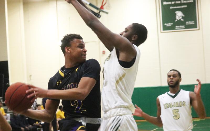 Columbia guard Amare Ferrell’s drive is stopped by a Lincoln defender Tuesday night in the Region 1-6A semifinals. (JORDAN KROEGER/Lake City Reporter)