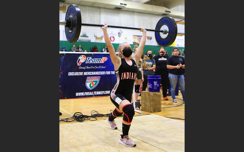 Fort White’s Katie Griffith finishes her clean and jerk en route to the state title in the 101 class.