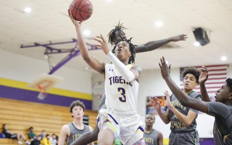 Columbia guard Charleston Ponds rises for a layup against Trinity Catholic on Tuesday night. (BRENT KUYKENDALL/Lake City Reporter)