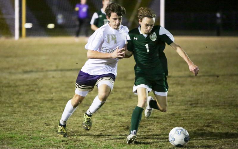 Columbia’s Trey Hingson chases after possession of the ball from Lincoln’s Brody Miller during Monday’s District 2-6A championship. (BRENT KUYKENDALL/Lake City Reporter)