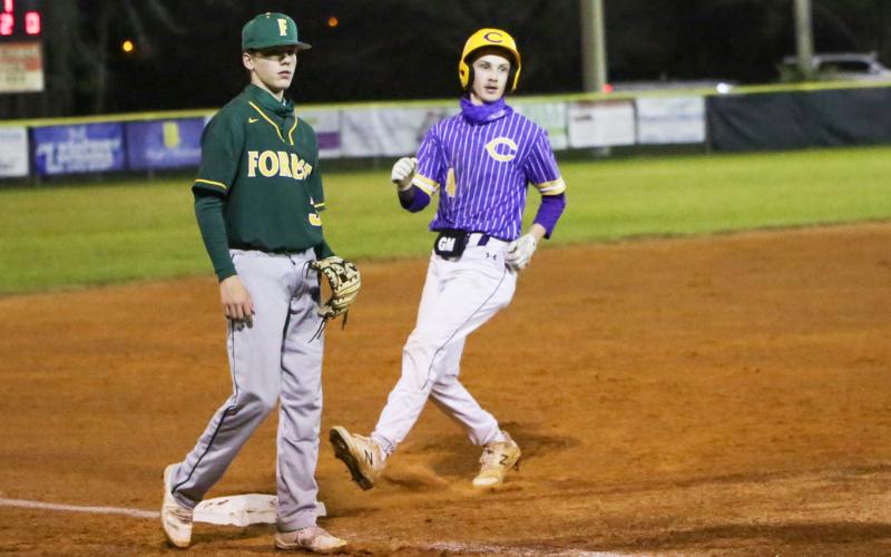 Columbia's Bryant Green strolls into third base against Forest on Thursday night. (BRENT KUYKENDALL/Lake City Reporter)