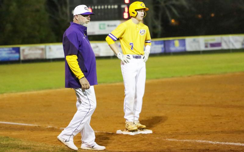 Columbia outfielder Kade Jackson stands on third base alongside coach Brian Thomas during Friday night’s game against Baker County. (BRENT KUYKENDALL/Lake City Reporter)
