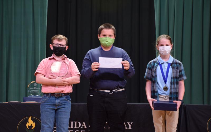 The Suwannee Valley Science Fair was held Thursday at Florida Gateway College with Fort White High School and Fort White Middle School taking home the top honors with the best overall winner in both the junior and senior divisions. Winning the Best Overall Junior Division Award were Fort White’s Cyler Robinson (from left), Jonaz Watson and Kelly Burton for their project, ‘Effect of Organic and Inorganic Fertilizers of Collard Green Growth and Soil Health.’ (COURTESY)