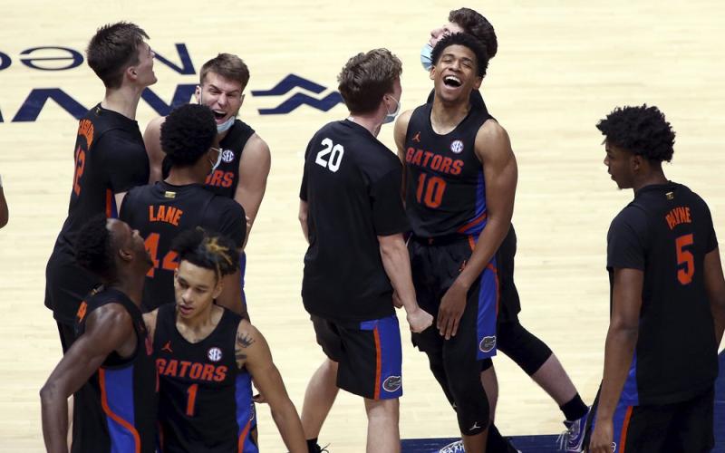 Florida players celebrate after a win against West Virginia on Jan. 30 in Morgantown, W.Va. (KATHLEE BATTEN/Associated Press)