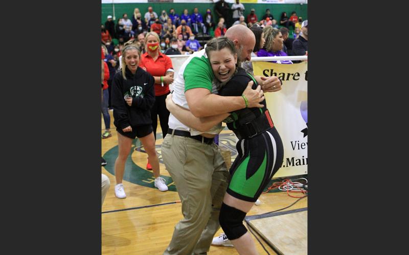 Suwannee assistant coach Dan Marsee (left) celebrates with Maddie Carte during the Class 1A state meet on Friday. She placed third in the 183 class. (PAUL BUCHANAN/Special to the Reporter)