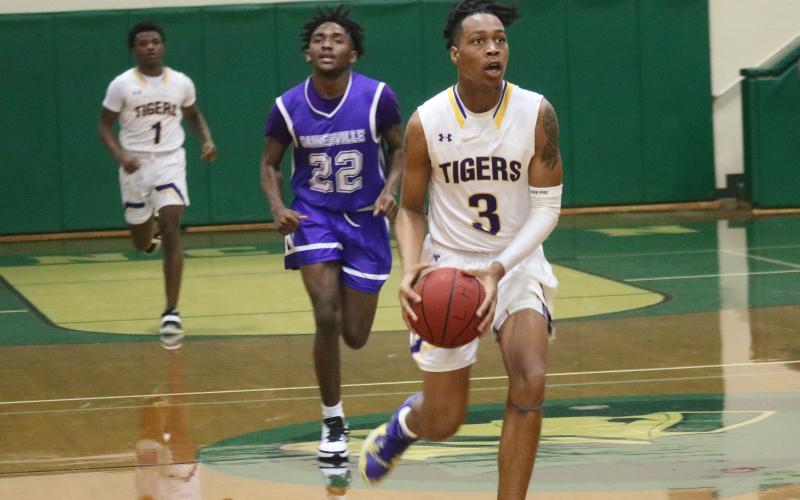 Columbia guard Charleston Ponds pushes the ball up the floor in transition against Gainesville during the District 2-6A semifinals Wednesday night at Lincoln High School. (JORDAN KROEGER/Lake City Reporter)