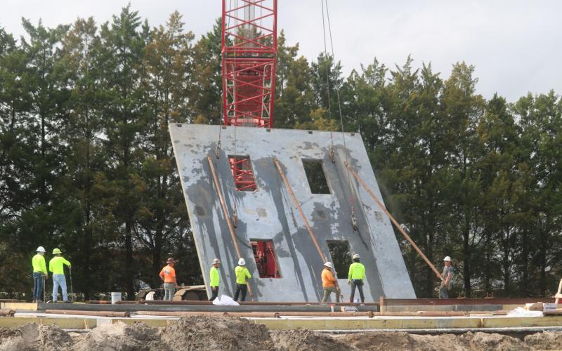 Construction crews lift a wall for the new two-story Belmont Academy building on Tuesday. The walls were being erected Tuesday and Wednesday with the facility expected to open this fall. (TONY BRITT/Lake City Reporter)