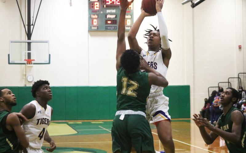 Columbia forward Charleston Ponds shoots over Lincoln forward Bryce Cummings during Friday’s District 2-6A championship. (JORDAN KROEGER/Lake City Reporter)