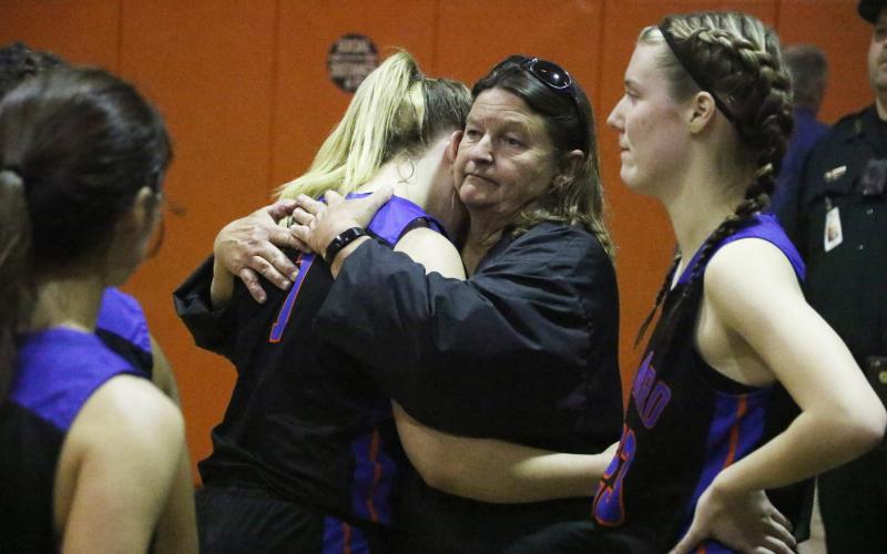 Branford forward Cera McElreath hugs head coach Carla Suggs following Tuesday’s loss to Trenton in the Region 3-1A finals. (MORGAN MCMULLEN/Lake City Reporter)