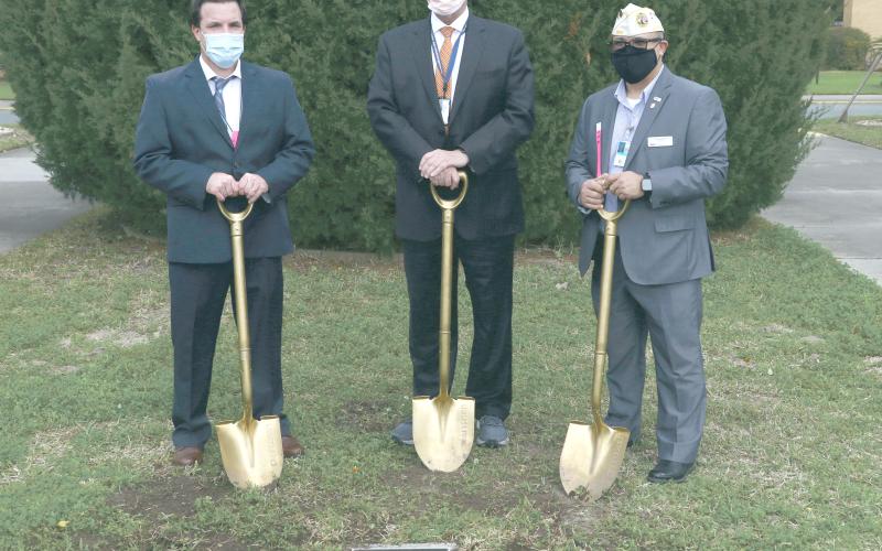 Lake City VA Medical Center Associate Director Chad Adams (from left), North Florida/South Georgia Veterans Health System Director Tom Wisnieski and Disabled American Veterans state commander Thomas Ayala took turns digging into the west lawn of the Lake City VA Medical Center yesterday. (MORGAN MCMULLEN/Lake City Reporter)