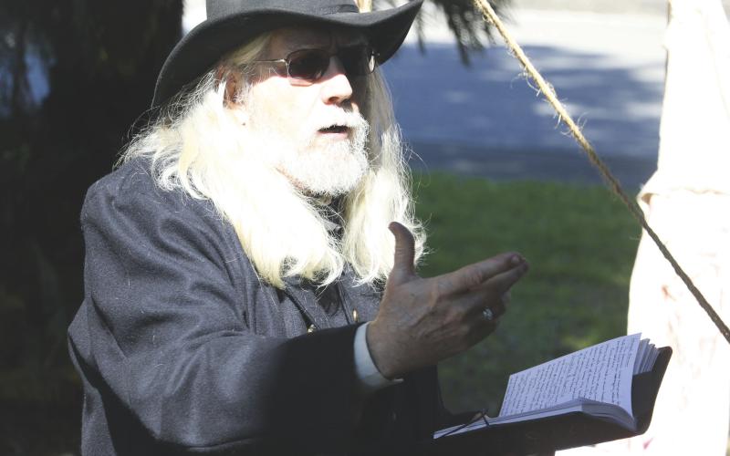 Lake City-Columbia County Historical Museum volunteer Harry Joiner reads an excerpt from the diary of a Civil War doctor on treating wounded men on Saturday. (MORGAN MCMULLEN/Lake City Reporter)