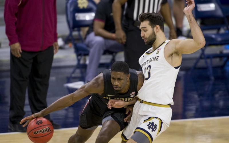 Florida State's Sardaar Calhoun, left, drives in as Notre Dame's Nikola Djogo (13) defends during the second half Saturday in South Bend, Ind. Notre Dame won 83-73. (ROBERT FRANKLIN/Associated Press)