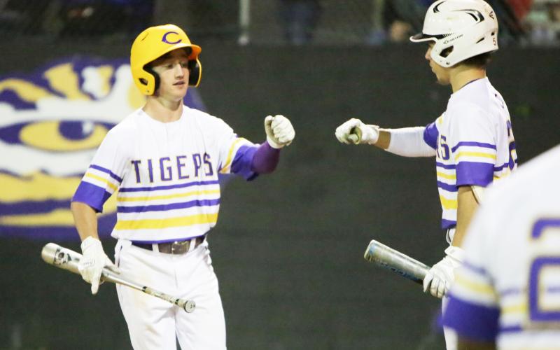 Columbia’s Matthew Dumas fist bumps with Cole Williams after scoring a run against Stanton on Tuesday night. (BRENT KUYKENDALL/Lake City Reporter)