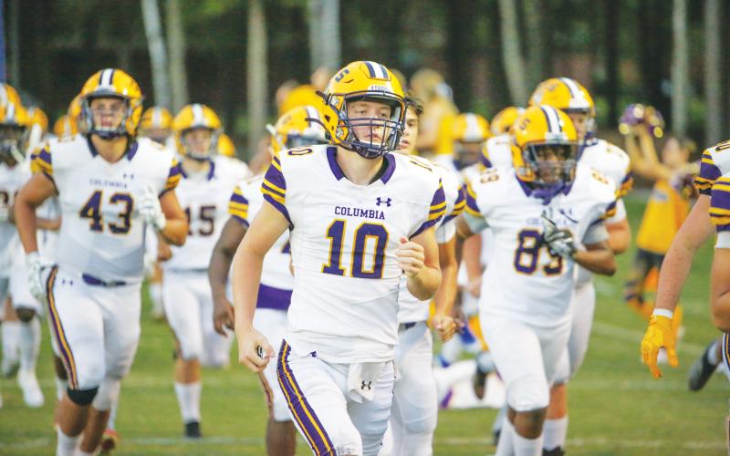 Columbia quarterback Kade Jackson leads his team on the field before a game last season. (FILE)