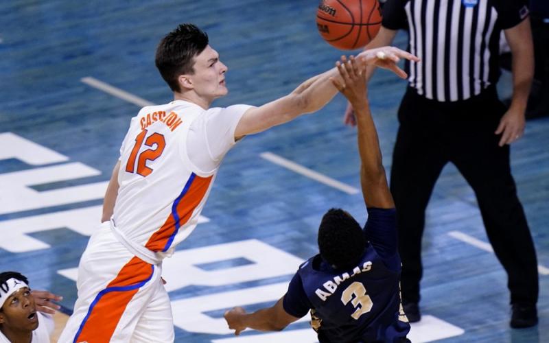 Florida forward Colin Castleton (12) blocks a shot by Oral Roberts guard Max Abmas (3) during the second round of the NCAA Tournament at Indiana Farmers Coliseum on March 21 in Indianapolis. (AJ MAST/Associated Press)