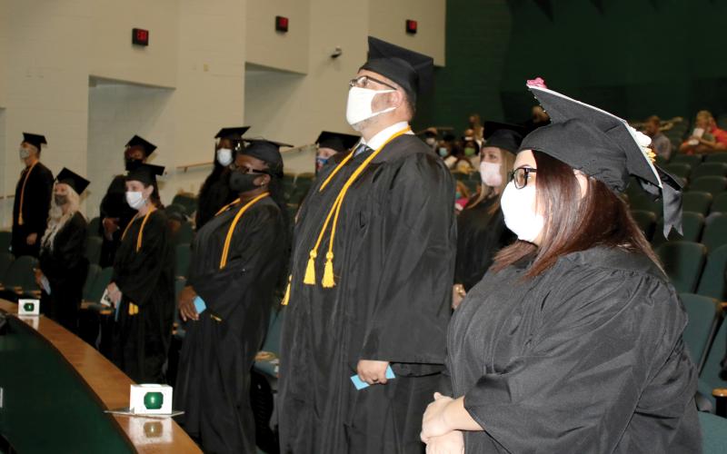 Florida Gateway College graduates await the start of their commencement ceremony in December. The college is continuing to hold small group graduation exercises this spring. (FILE)